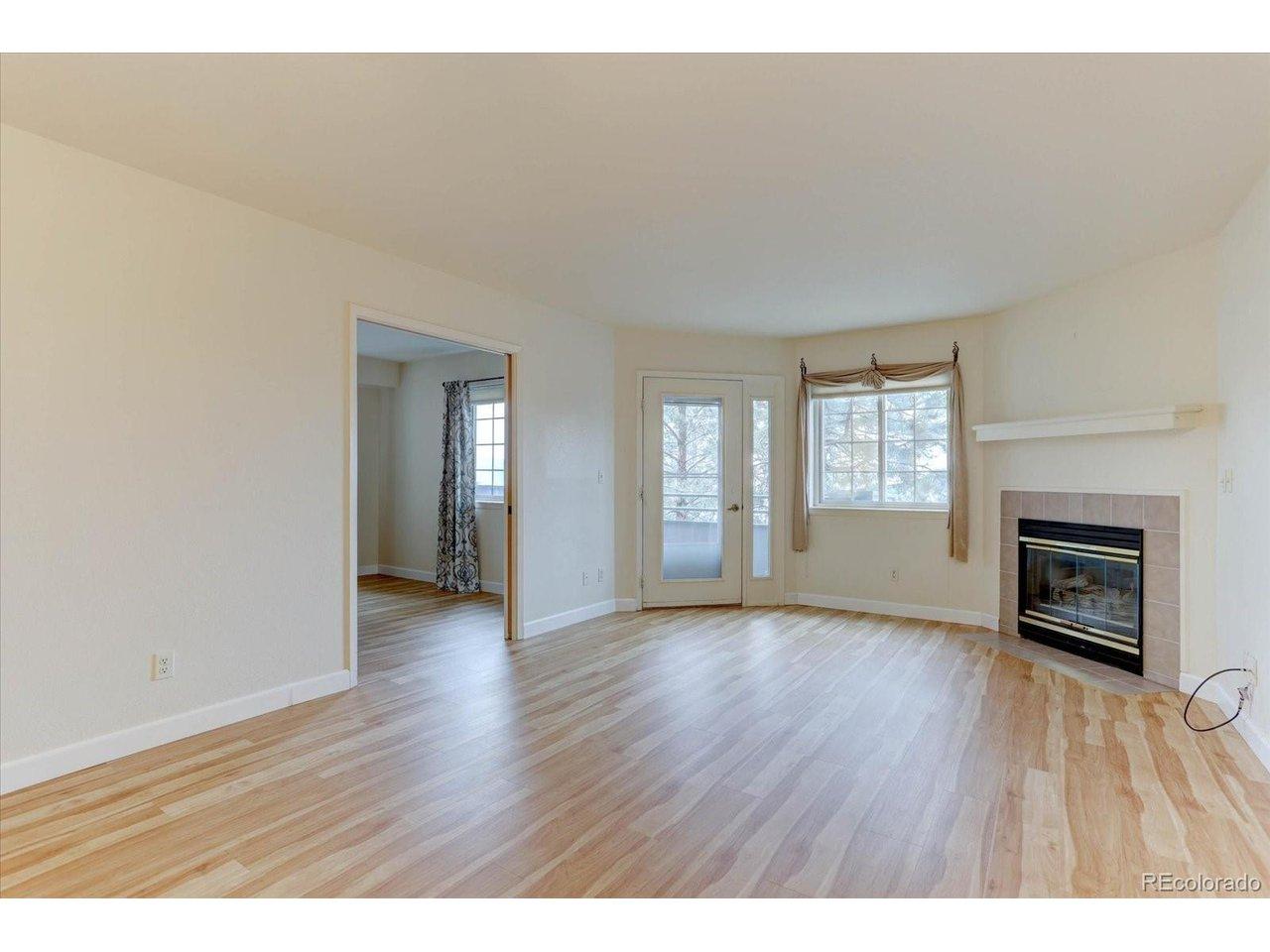 Image 2: Beautiful living room with wood floors and fireplace!