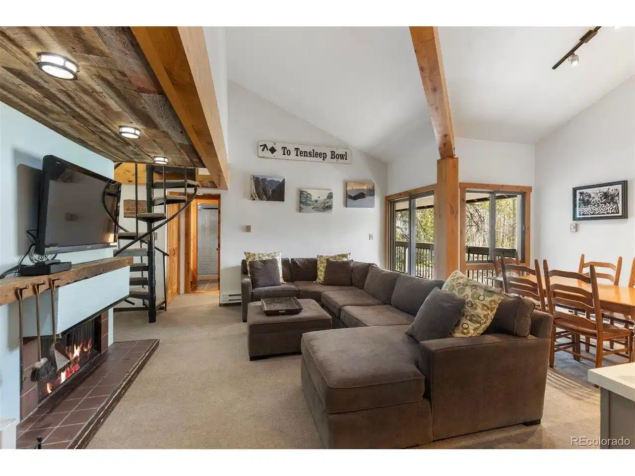Image 1: Living room with an open floor plan. highlighting the spacious layout and natural lighting.