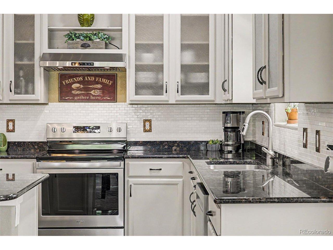 Image 2: Custom upper cabinets with glass pane, stove and rangehood. Image 2: Custom upper cabinets with glass pane, stove and rangehood.