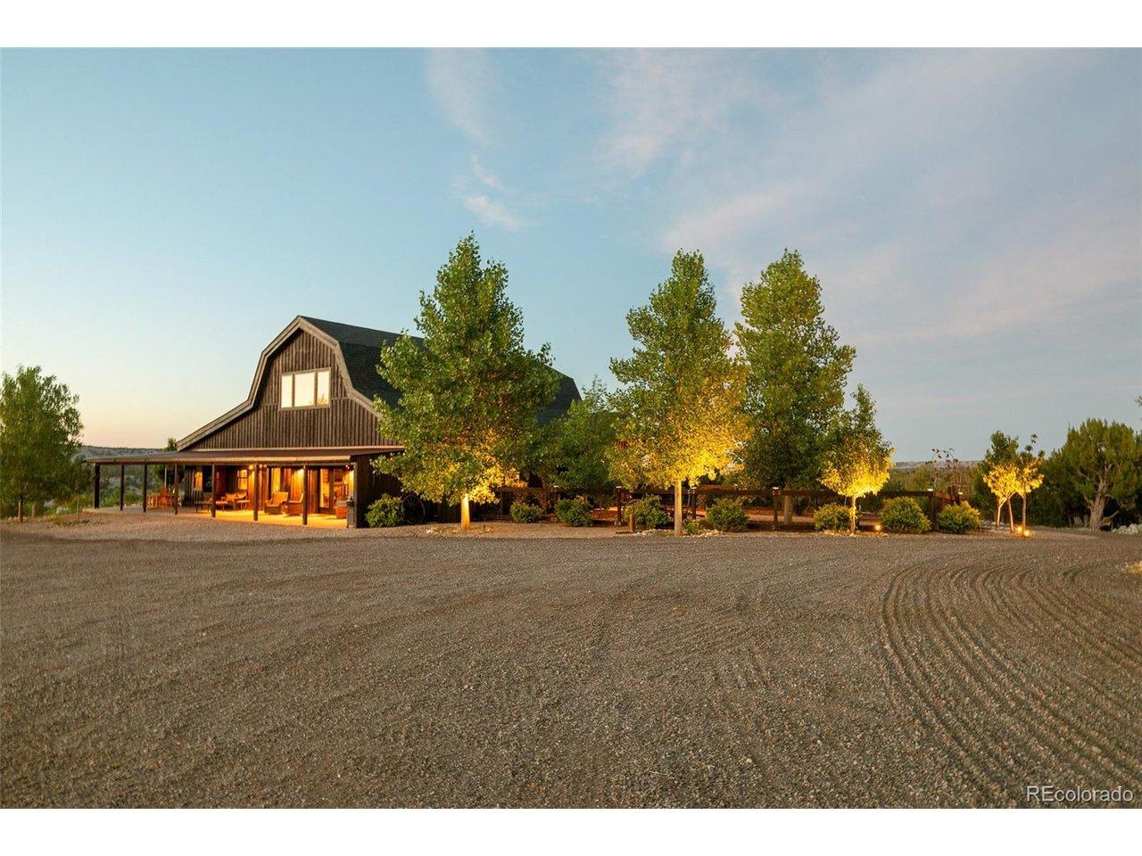 Image 1: The custom timber-frame residence is surrounded by established landscaping and expansive gravel surfaces, creating a welcoming arrival within the private 40-acre setting. Image 1: The custom timber-frame residence is surrounded by established landscaping and expansive gravel surfaces, creating a welcoming arrival within the private 40-acre setting.