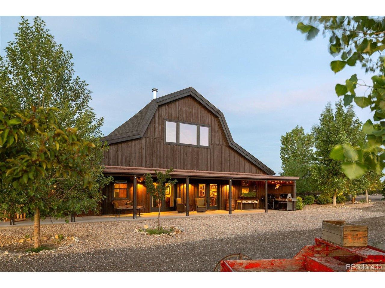 Image 2: Natural rough-cut wood siding, expansive windows and a deep covered porch give the residence a distinctive ranch-inspired presence. Image 2: Natural rough-cut wood siding, expansive windows and a deep covered porch give the residence a distinctive ranch-inspired presence.