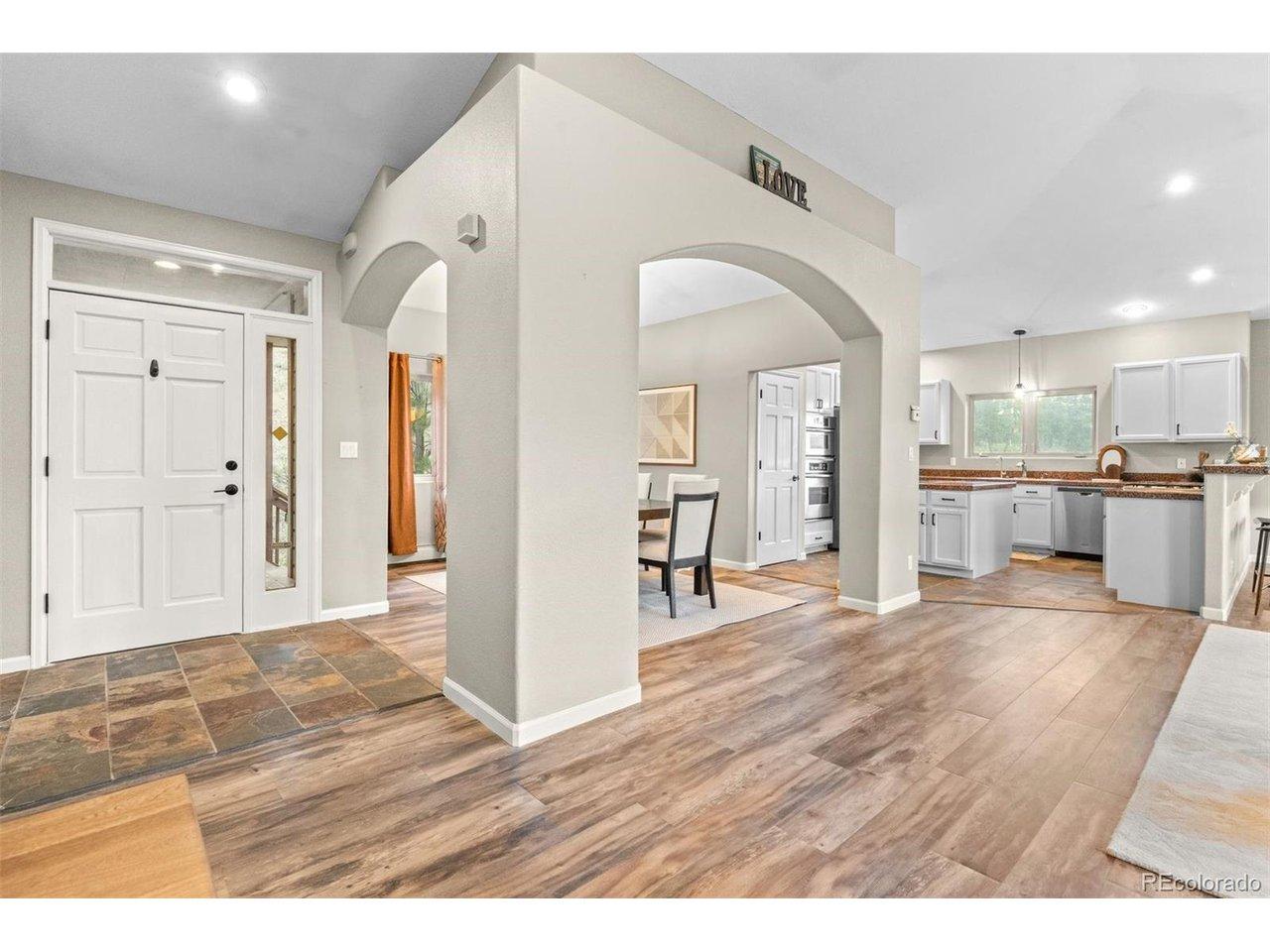 Image 4: The contemporary arches create an integrated flow while identifying separate spaces. Entry and Kitchen have slate tile floors. LVP compliments the tile. Image 4: The contemporary arches create an integrated flow while identifying separate spaces. Entry and Kitchen have slate tile floors. LVP compliments the tile.
