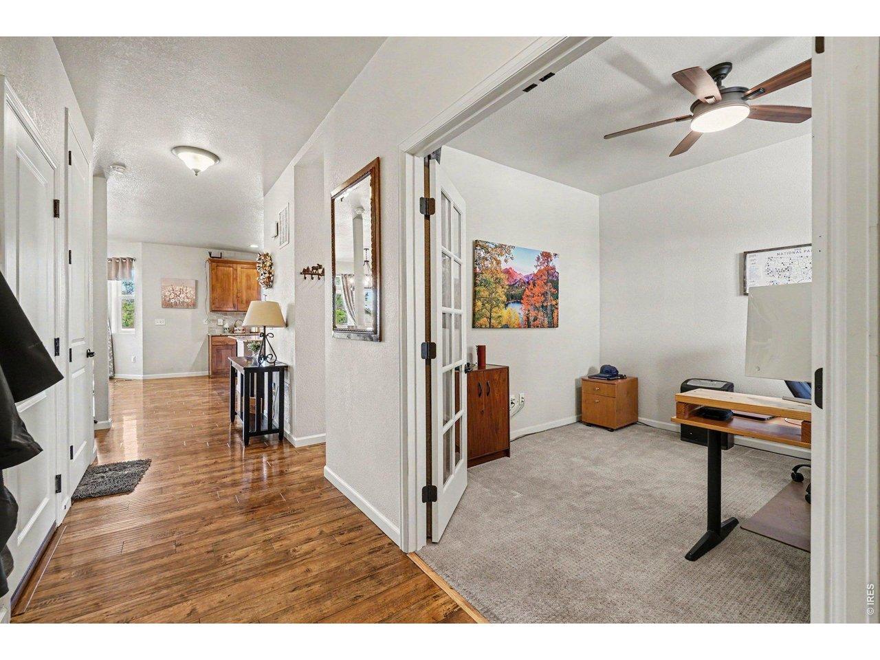 Image 4: front door entry, garage door left, basement door left, staircase left, dining area ahead & kitchen, 1/2 bath hallway on the right, study on the right