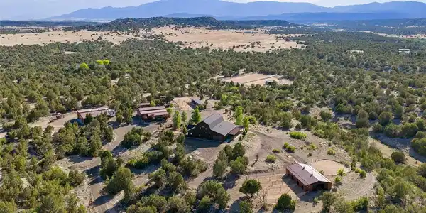 Image 4: The 40-acre estate unfolds across a varied Southern Colorado landscape, with the residence, equestrian facilities and outbuildings positioned throughout the grounds. Image 4: The 40-acre estate unfolds across a varied Southern Colorado landscape, with the residence, equestrian facilities and outbuildings positioned throughout the grounds.
