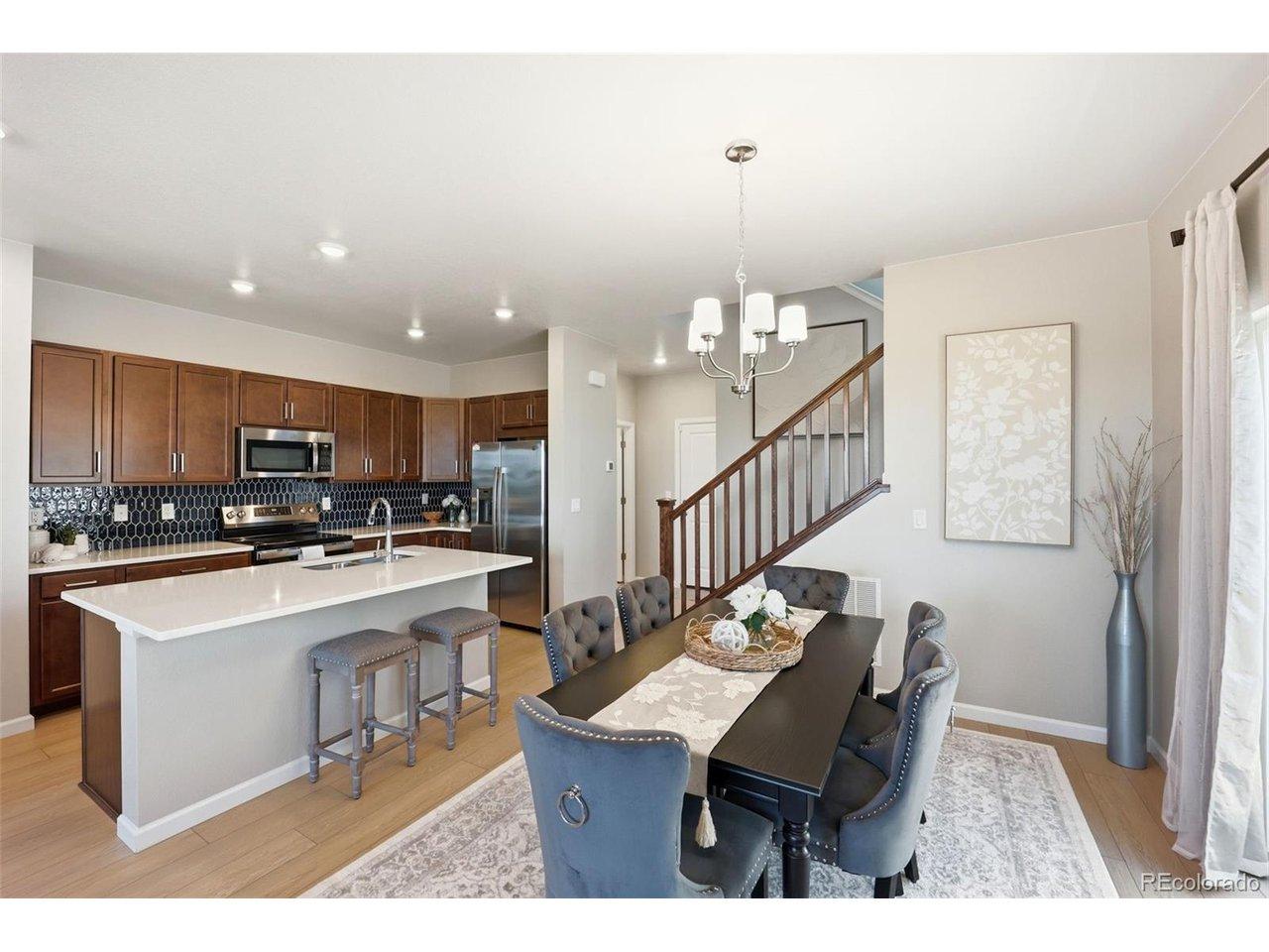 Image 4: Kitchen and dining area showcasing the home's seamless open-concept floor plan. Image 4: Kitchen and dining area showcasing the home's seamless open-concept floor plan.