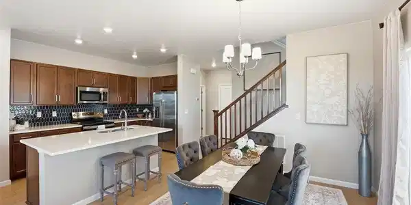 Image 4: Kitchen and dining area showcasing the home's seamless open-concept floor plan.
