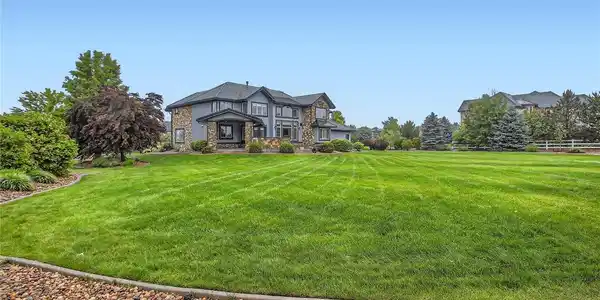 Image 2: Extensive landscaped yard perfect for football, soccer, baseball or a host of outdoor activities, with ample space for the addition of future pool and sports court, further enhancing the outdoor living experience