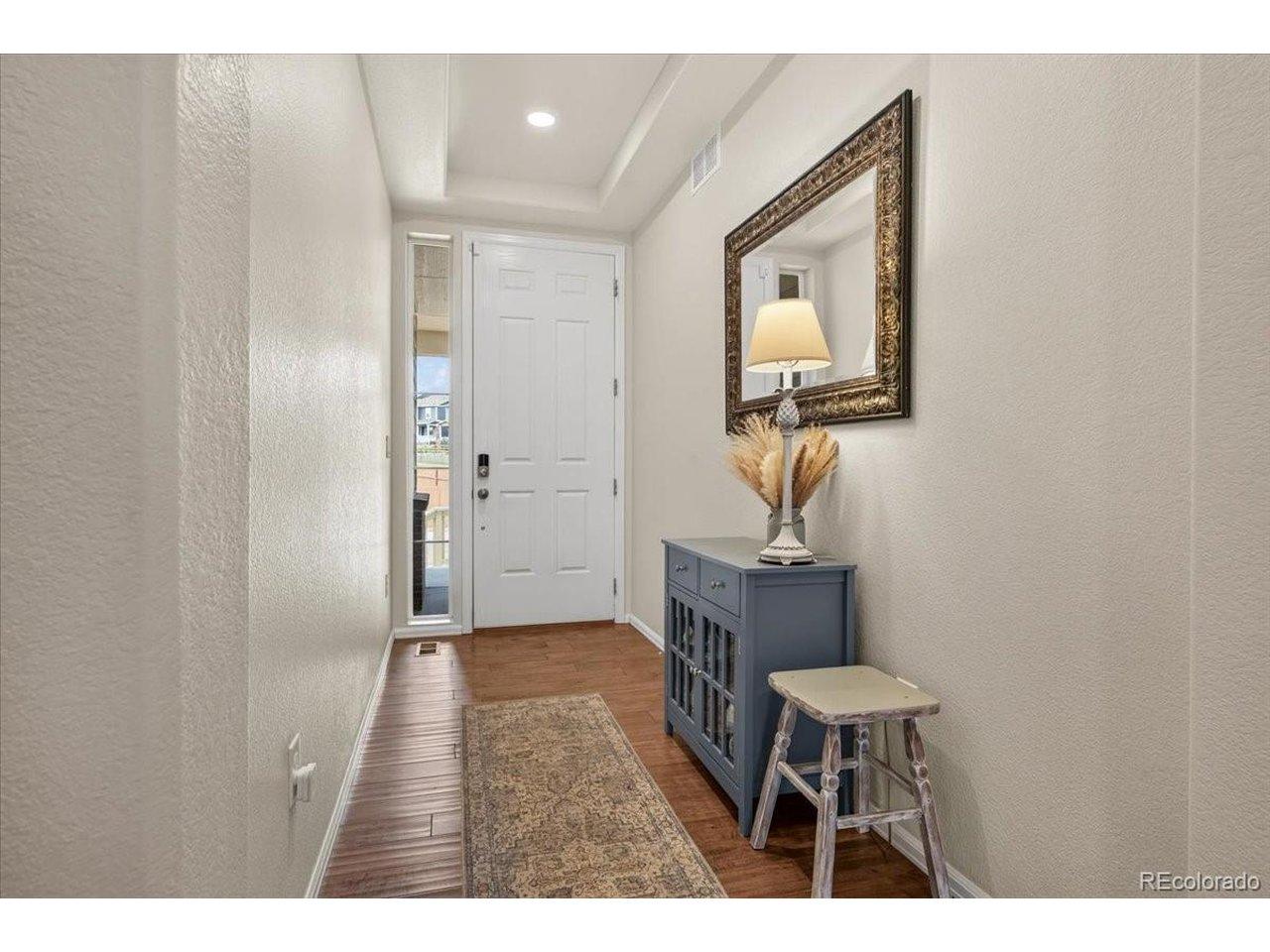 Image 4: Step inside to a welcoming foyer featuring engineered hardwood flooring and an open floor plan that immediately feels warm and inviting. Image 4: Step inside to a welcoming foyer featuring engineered hardwood flooring and an open floor plan that immediately feels warm and inviting.