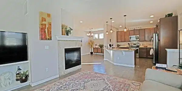 Image 4: LR to kitchen, double sided fireplace, spacious and open