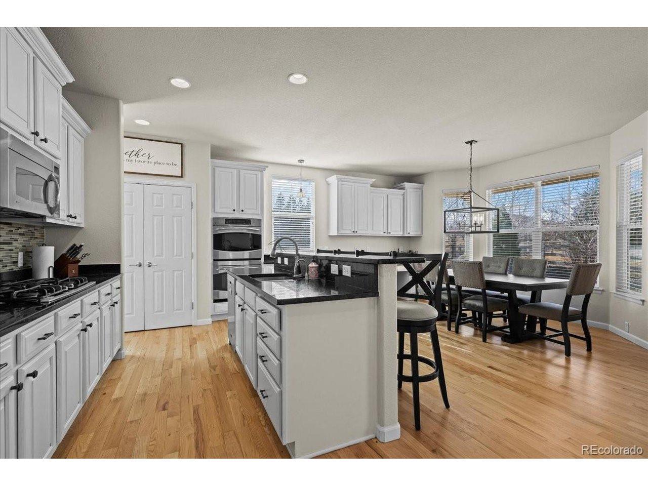 Image 3: Kitchen with hardwood floors, granite counters and a large pantry Image 3: Kitchen with hardwood floors, granite counters and a large pantry