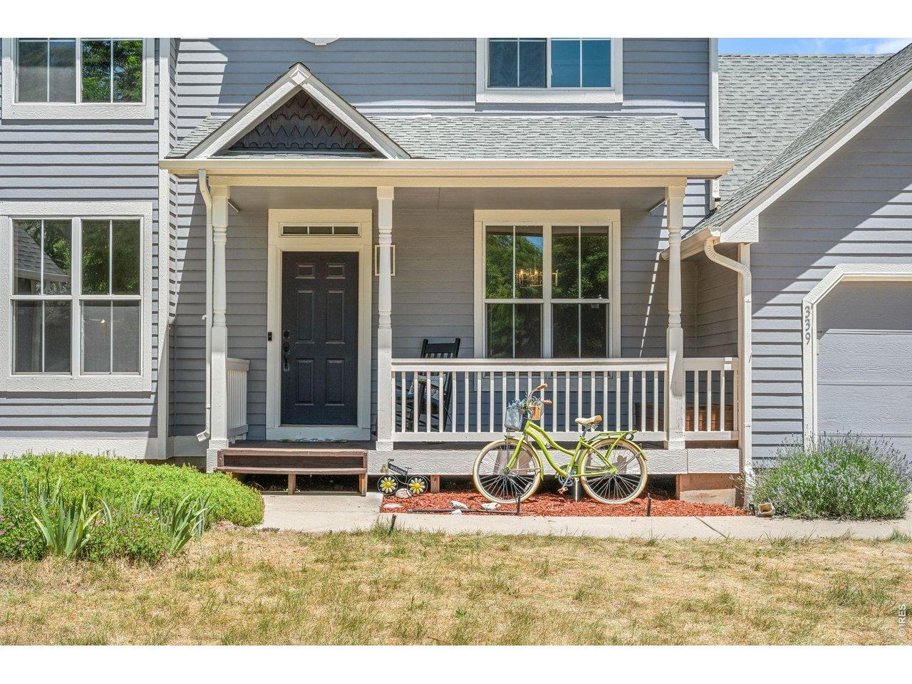Image 2: Covered porch with white picket fence