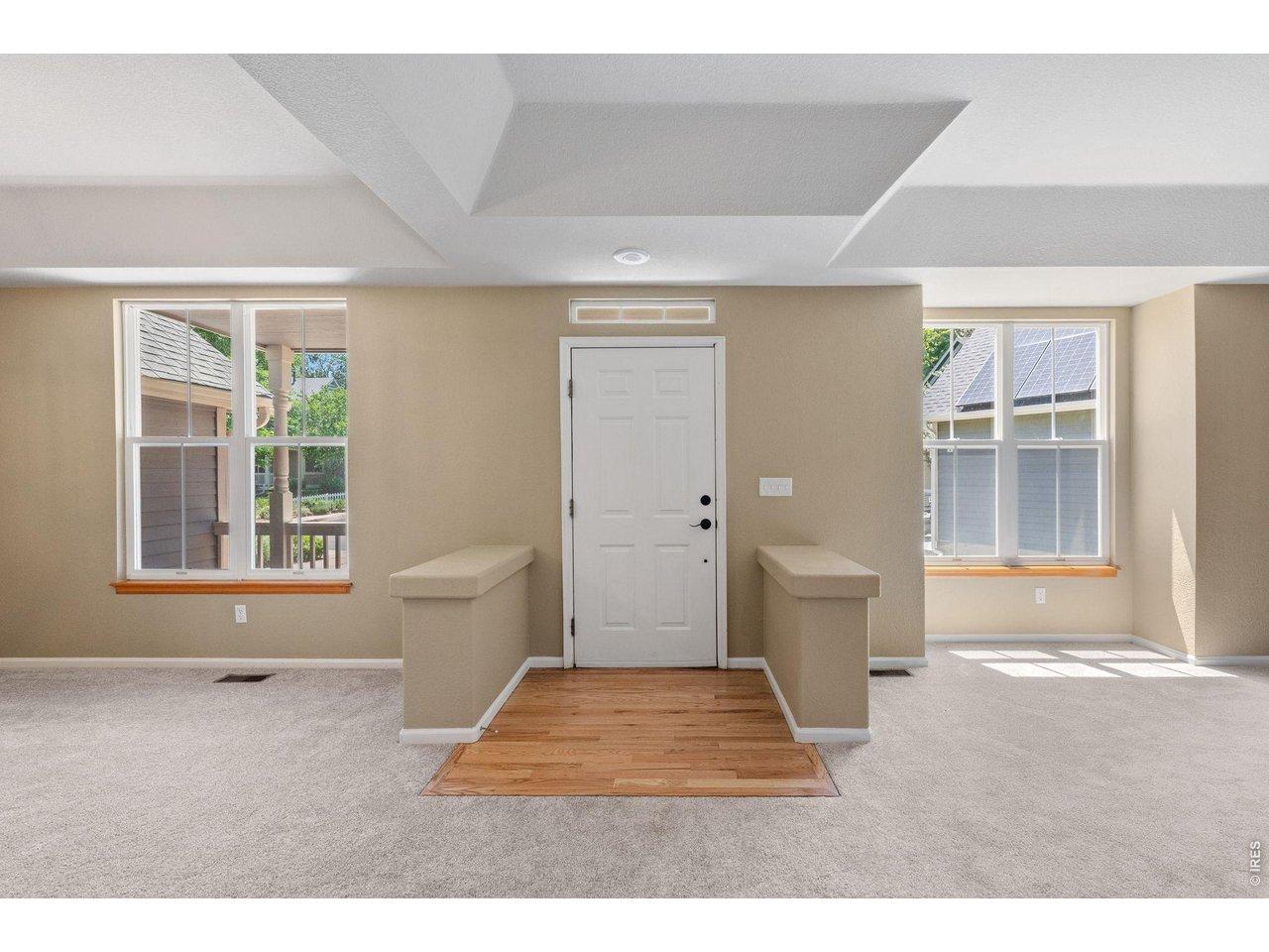 Image 4: Entry way with hardwood floor and carpet combo