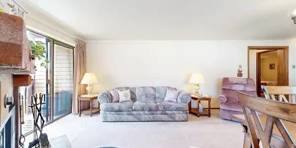 Image 3: Open and lightfilled living room opens up to kitchen area and offers sliding glass doors to a private balcony Image 3: Open and lightfilled living room opens up to kitchen area and offers sliding glass doors to a private balcony