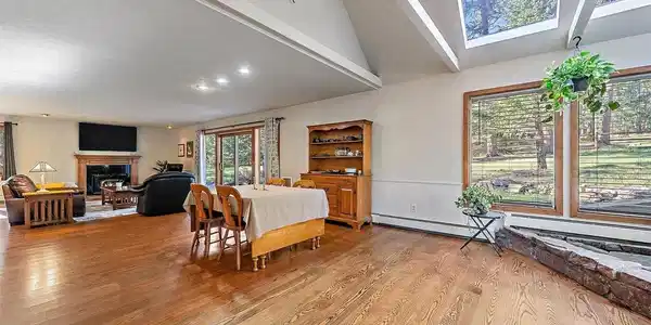 Image 4: Light and bright great room with vaulted ceilings and skylights, hardwood floors and expansive windows. Image 4: Light and bright great room with vaulted ceilings and skylights, hardwood floors and expansive windows.