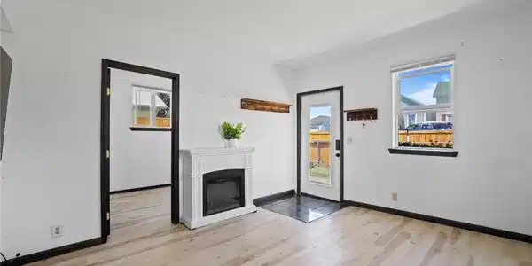 Image 4: Living room. New flooring, trim, blinds and front door