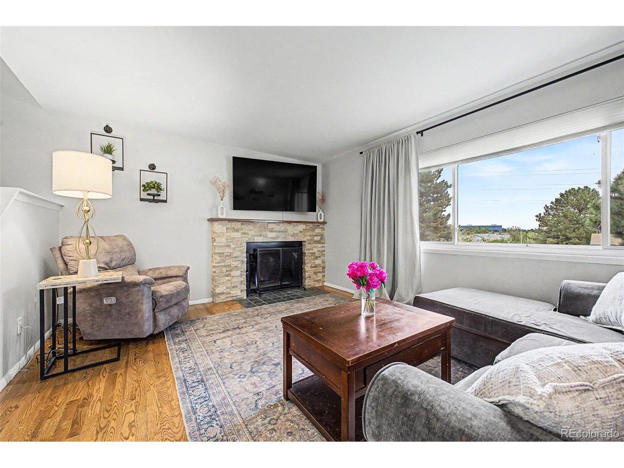 Image 4: Wood burning fireplace for those cold winter evenings. Beautiful hardwood flooring throughout main level. Image 4: Wood burning fireplace for those cold winter evenings. Beautiful hardwood flooring throughout main level.