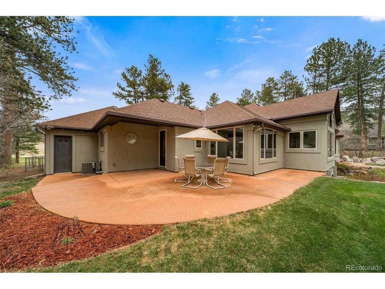 Image 1: Poured patio with included furniture, offering easy access to both the garage and kitchen. Image 1: Poured patio with included furniture, offering easy access to both the garage and kitchen.