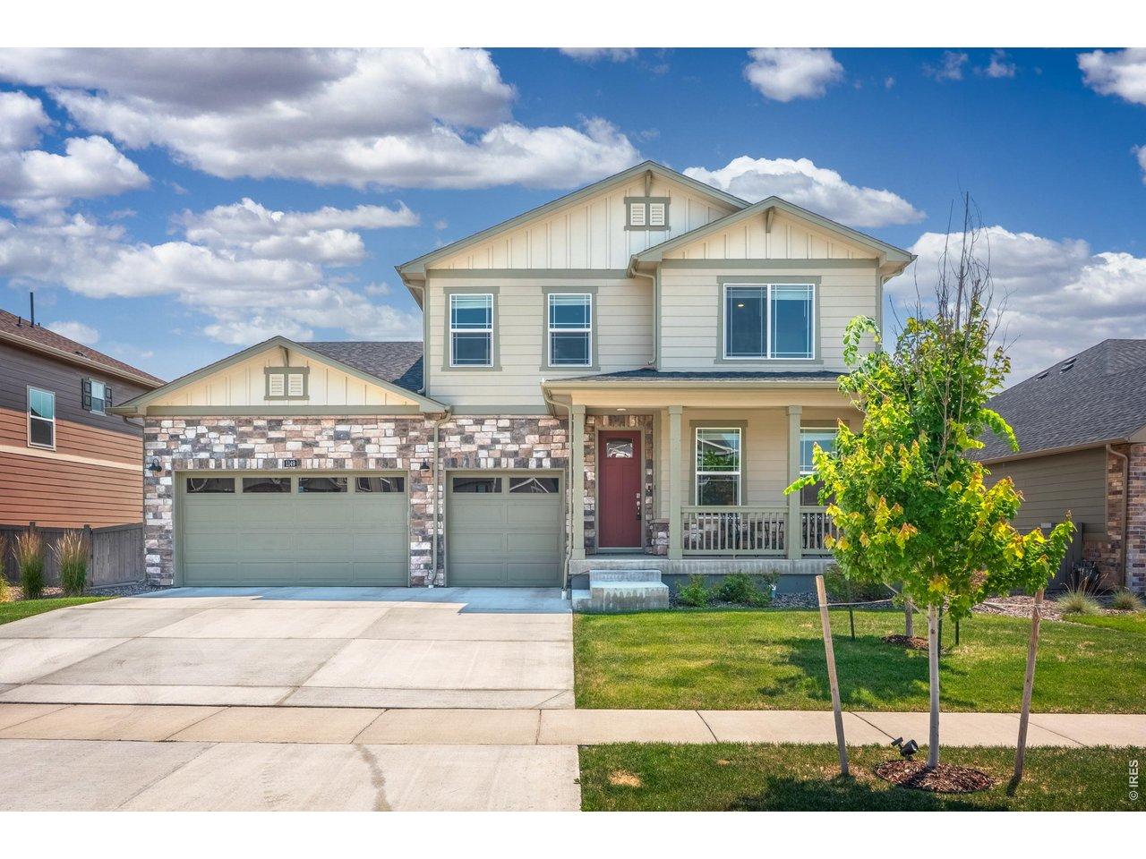 Image 2: A two-story craftsman with stone accents, a 3-car garage, and a covered front porch. Image 2: A two-story craftsman with stone accents, a 3-car garage, and a covered front porch.