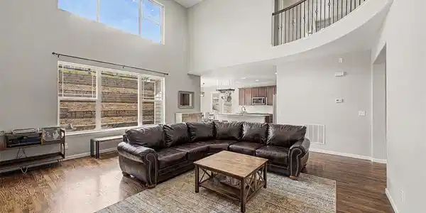 Image 2: Dramatic Two-Story Family Room with Expansive Windows & Open Loft Above Image 2: Dramatic Two-Story Family Room with Expansive Windows & Open Loft Above