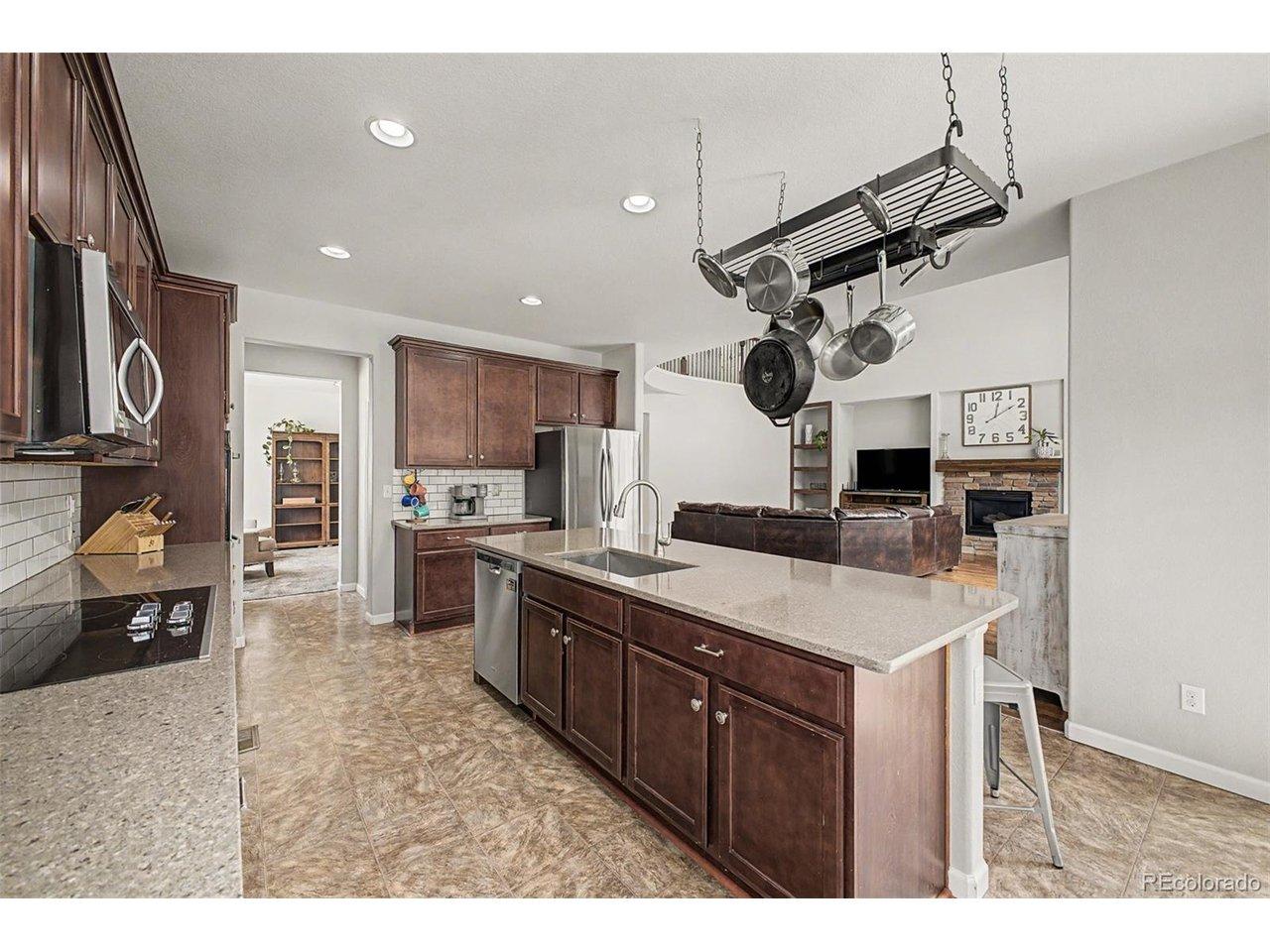 Image 3: Spacious kitchen with oversized island, abundant cabinetry, and open-concept layout