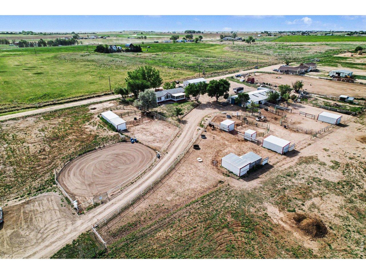 Image 1: Aerial view of the home looking southeast. The property has a 3 bedroom/2 bathroom home plus a 6 stall barn with pipe runs, multiple horse sheds, a detached shop, hay barn, a large arena and so much more! Image 1: Aerial view of the home looking southeast. The property has a 3 bedroom/2 bathroom home plus a 6 stall barn with pipe runs, multiple horse sheds, a detached shop, hay barn, a large arena and so much more!