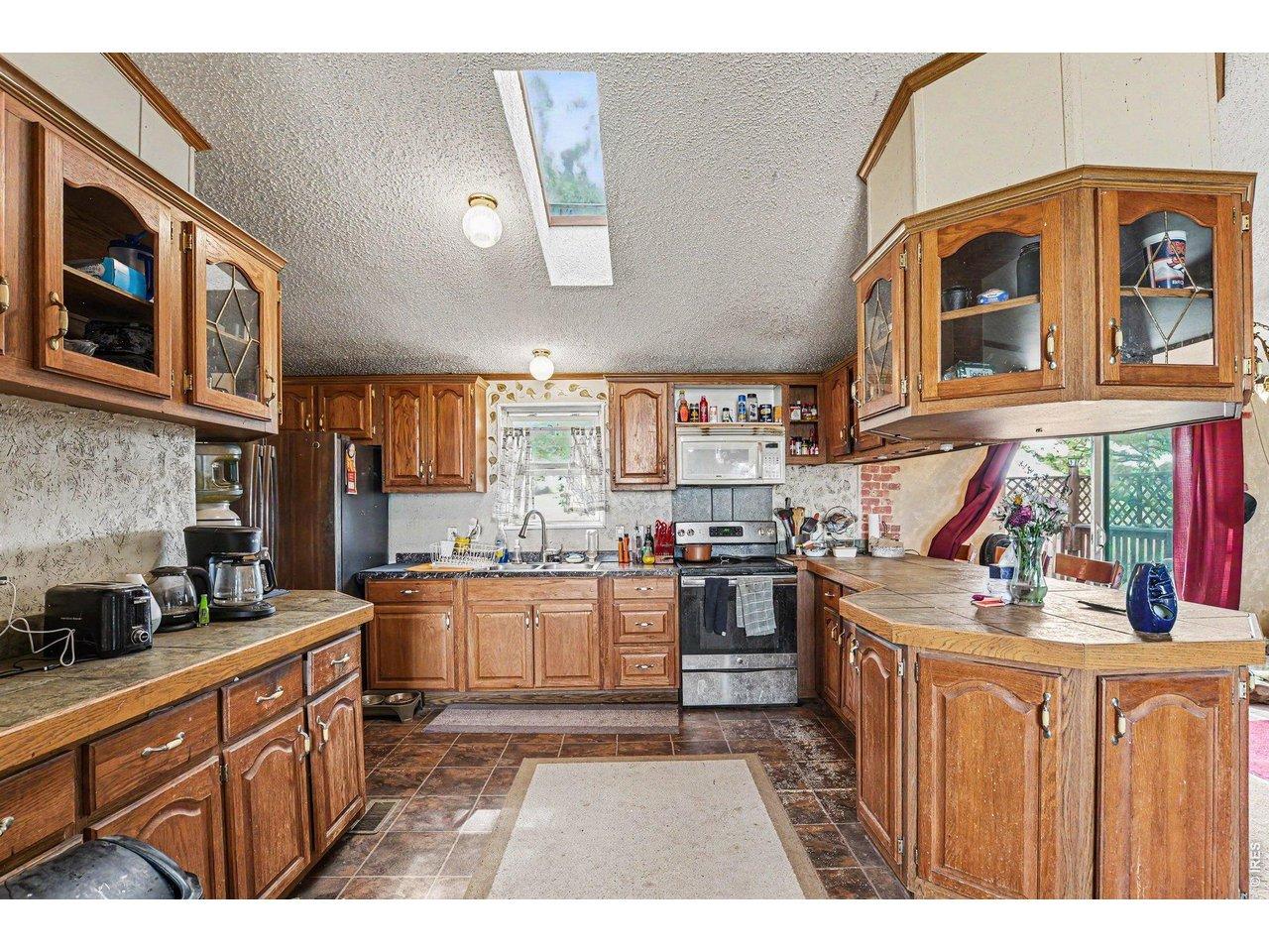 Image 4: Kitchen with tons of cabinetry for storage. A skylight provides more natiral light. Image 4: Kitchen with tons of cabinetry for storage. A skylight provides more natiral light.