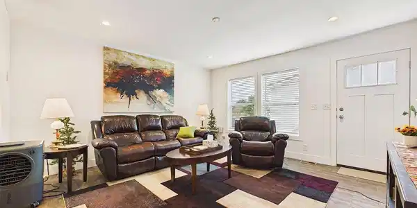Image 3: Bright living room with large windows, recessed lighting, durable wood-look flooring, and an open layout designed to flow naturally into the adjoining living spaces. Image 3: Bright living room with large windows, recessed lighting, durable wood-look flooring, and an open layout designed to flow naturally into the adjoining living spaces.