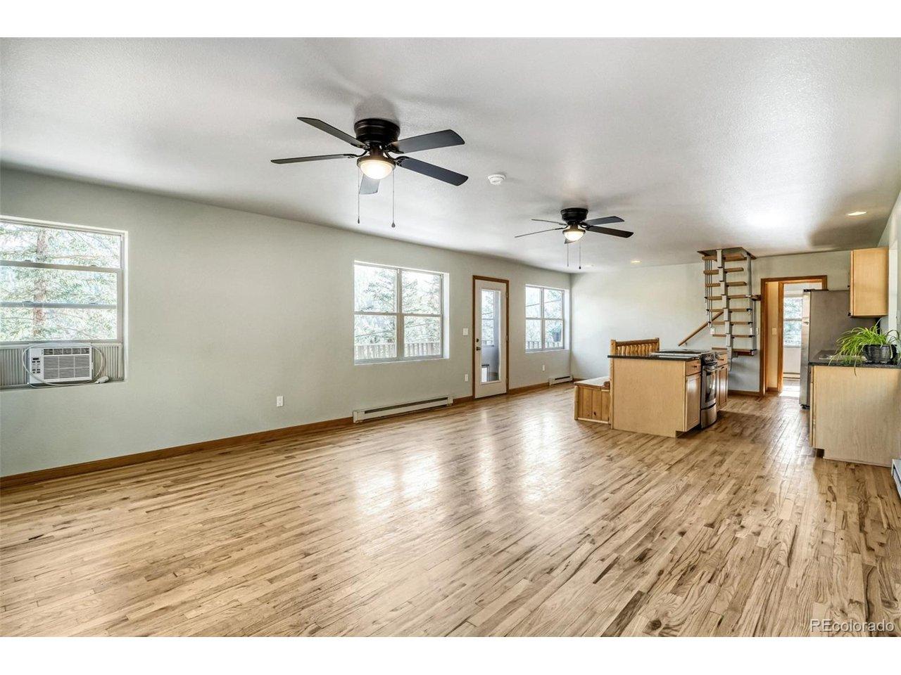 Image 4: Bright, open-concept living with beautiful wood flooring, abundant natural light, and seamless flow into the kitchen. Image 4: Bright, open-concept living with beautiful wood flooring, abundant natural light, and seamless flow into the kitchen.