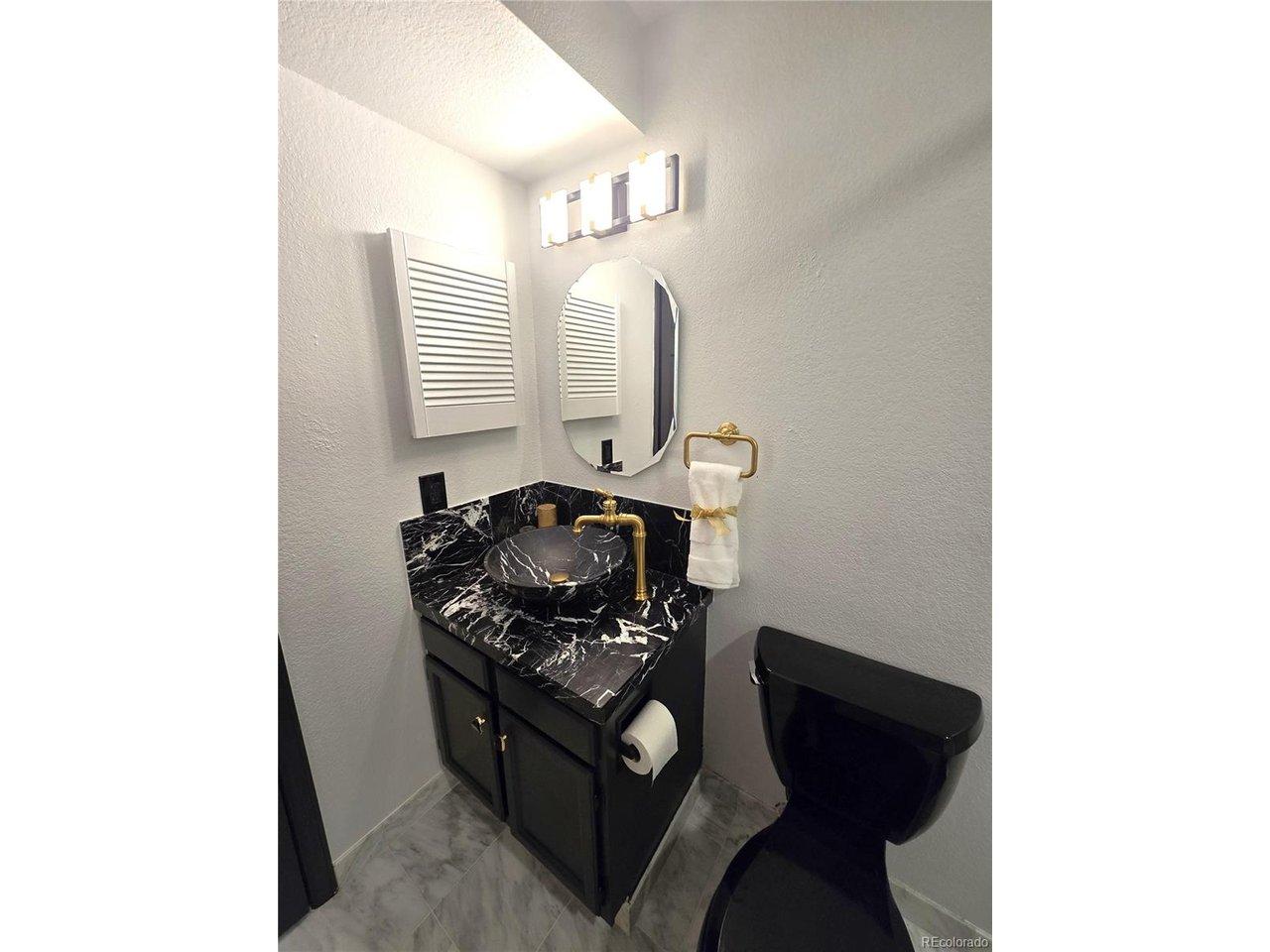 Image 3: Spa-like bath updated with brushed gold and marble!