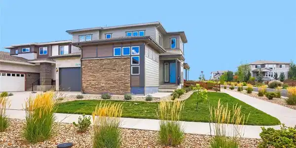 Image 2: This contemporary Candelas home showcases striking stone accents, inviting curb appeal, and beautifully maintained landscaping. Image 2: This contemporary Candelas home showcases striking stone accents, inviting curb appeal, and beautifully maintained landscaping.