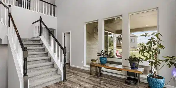 Image 3: The soaring two-story foyer welcomes you with abundant natural light, modern flooring, and an elegant staircase. Image 3: The soaring two-story foyer welcomes you with abundant natural light, modern flooring, and an elegant staircase.