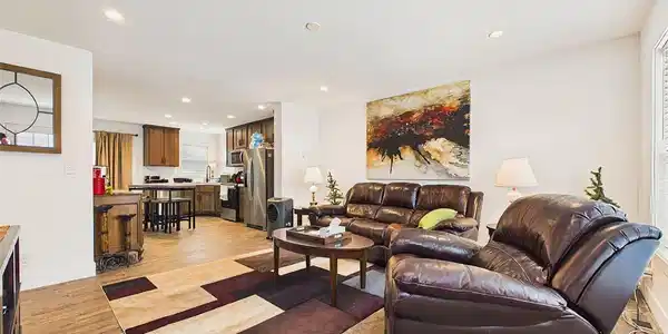 Image 4: Spacious living area opens directly toward the kitchen and dining space, creating a connected floor plan with abundant recessed lighting throughout. Image 4: Spacious living area opens directly toward the kitchen and dining space, creating a connected floor plan with abundant recessed lighting throughout.