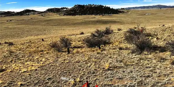 Image 2: View southwest over the property from the northeast corner pin