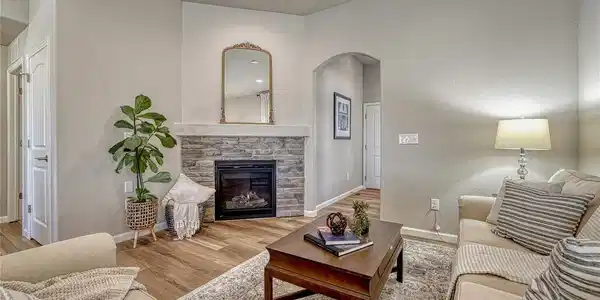 Image 4: Relax and unwind in the living room, where a corner stone gas-log fireplace creates a focal point within the open comfortable layout. Image 4: Relax and unwind in the living room, where a corner stone gas-log fireplace creates a focal point within the open comfortable layout.