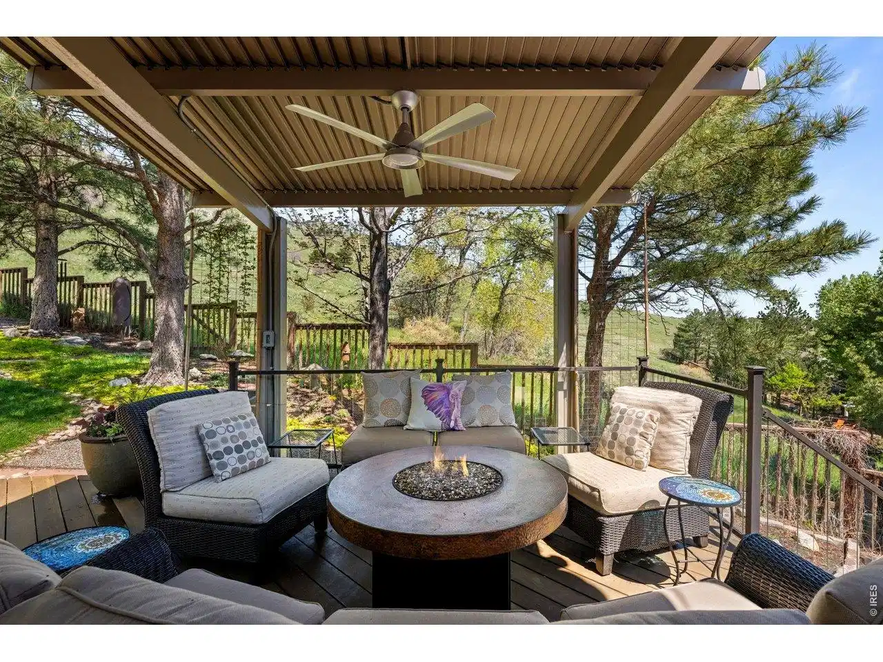Image 1: Private covered patio off the kitchen with comfortable seating arrangements and views of the foothills beyond. Image 1: Private covered patio off the kitchen with comfortable seating arrangements and views of the foothills beyond.