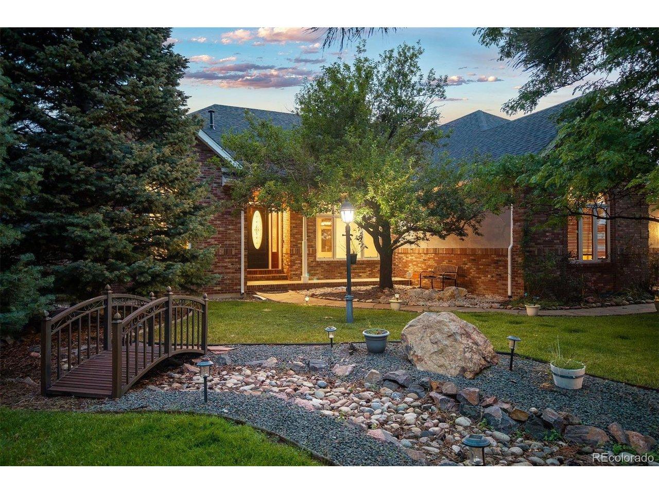 Image 3: Welcoming front entrance framed by mature trees, lush landscaping, and a charming footbridge. Image 3: Welcoming front entrance framed by mature trees, lush landscaping, and a charming footbridge.