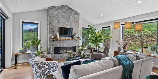 Image 3: Walls of windows and stacked stone fireplace Image 3: Walls of windows and stacked stone fireplace