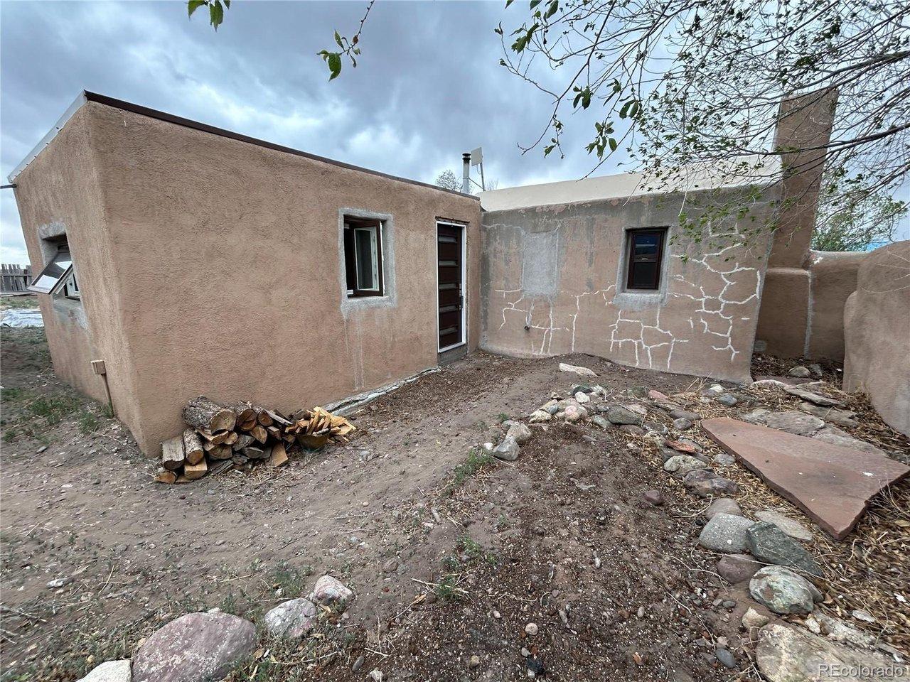 Image 3: Looking at home & front door from yard to the Southwest.