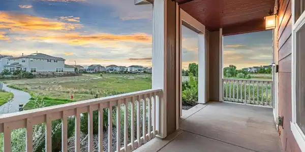 Image 2: Relax on the oversized covered front porch while taking in peaceful sunsets and neighborhood views. Image 2: Relax on the oversized covered front porch while taking in peaceful sunsets and neighborhood views.