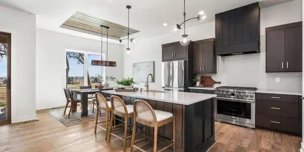 Image 4: The gourmet kitchen boasts a massive quartz island, stainless steel appliances, and elegant light fixtures Image 4: The gourmet kitchen boasts a massive quartz island, stainless steel appliances, and elegant light fixtures