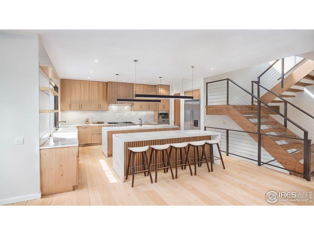 Image 4: Chefs kitchen - White Oak and Walnut cabinets. Wolf / Sub Zero appliances & Miele coffee system, Double island and walk-in pantry. Image is for rendering purposes only.