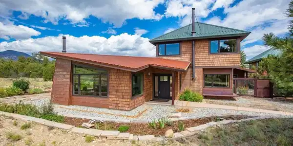 Image 2: 17121 Kiowa Rd, Nathrop CO 81236 - Mesa Antero Estates - 35.34 Acres. Hardie board siding, standing seam metal roofing, corrugated metal siding, and stone accents create a distinctive mountain contemporary exterior, while energy efficient Structural Insula Image 2: 17121 Kiowa Rd, Nathrop CO 81236 - Mesa Antero Estates - 35.34 Acres. Hardie board siding, standing seam metal roofing, corrugated metal siding, and stone accents create a distinctive mountain contemporary exterior, while energy efficient Structural Insula