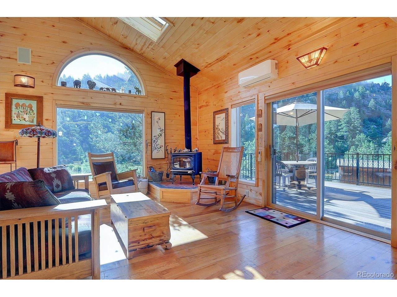 Image 3: The eastern family room with wood burning stove, patio access and natural light. Image 3: The eastern family room with wood burning stove, patio access and natural light.