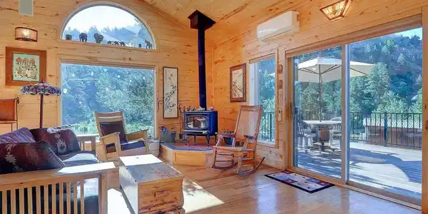 Image 3: The eastern family room with wood burning stove, patio access and natural light. Image 3: The eastern family room with wood burning stove, patio access and natural light.