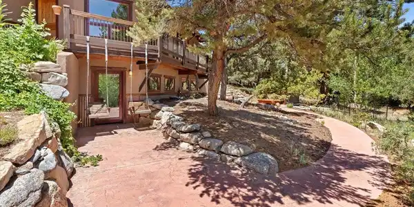 Image 4: Stamped concrete and paver patios meet professionally landscaped grounds with native grasses and rock retaining walls. Image 4: Stamped concrete and paver patios meet professionally landscaped grounds with native grasses and rock retaining walls.