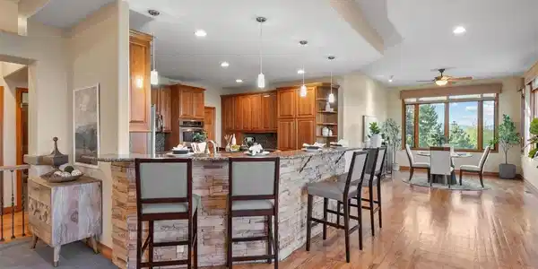 Image 2: Kitchen bar seating with warm cabinetry and views beyond - hard to leave in the morning Image 2: Kitchen bar seating with warm cabinetry and views beyond - hard to leave in the morning