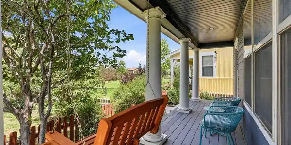 Image 3: Front Porch with mature plantings and trees in private corner of courtyard