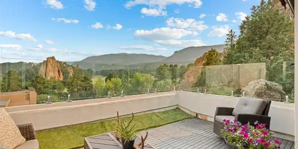 Image 4: Multiple outdoor living spaces frame the surrounding rock formations, golf course, and foothill views, creating a private place to relax above the landscape.
