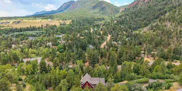 Image 2: Chautauqua Mountain rises above the property, showcasing the spectacular setting that surrounds the home. Image 2: Chautauqua Mountain rises above the property, showcasing the spectacular setting that surrounds the home.