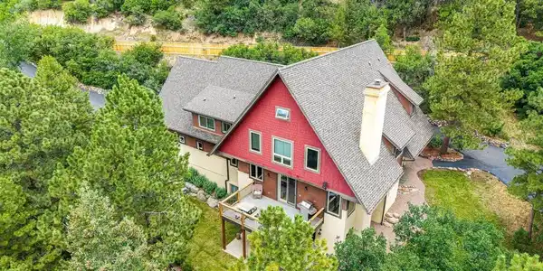 Image 4: An aerial view highlights the home's secluded setting on 2.21 wooded acres. Image 4: An aerial view highlights the home's secluded setting on 2.21 wooded acres.
